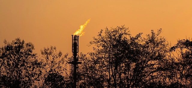 Mão retirando garrafa plástica de rio para limpeza e preservação ambiental