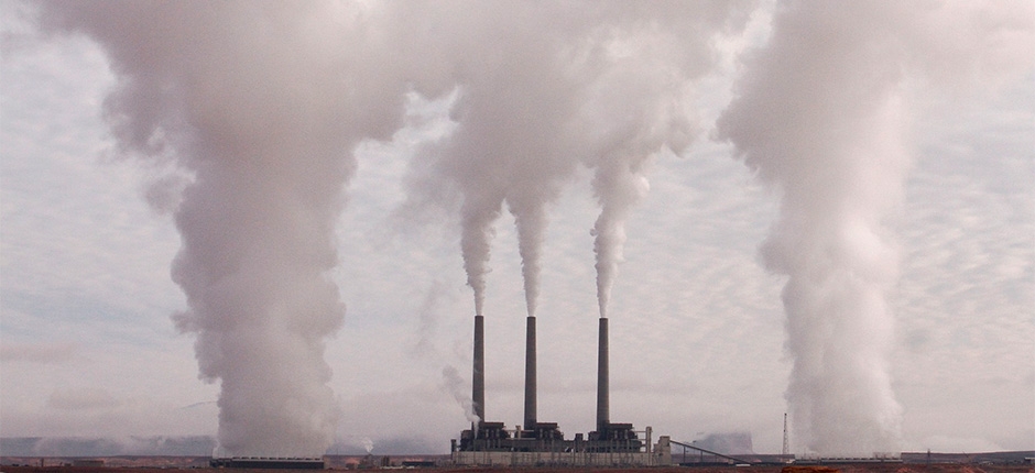 três chaminés emitindo grandes volumes de fumaça