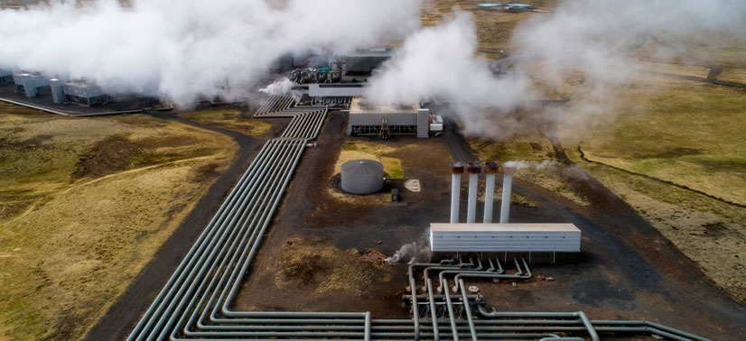 usina de energia geotérmica soltando vapor branco de suas chaminé