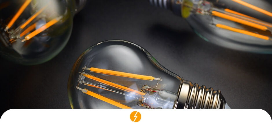 três lâmpadas sob um suporte de cor preta